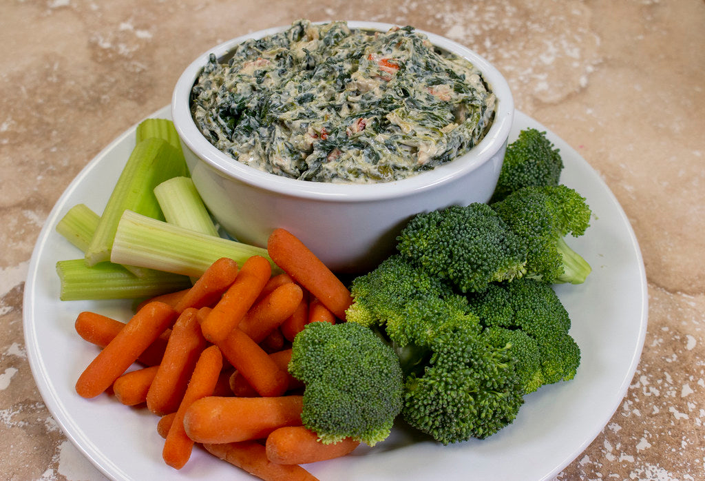 Plate of raw carrots, broccoli and celery