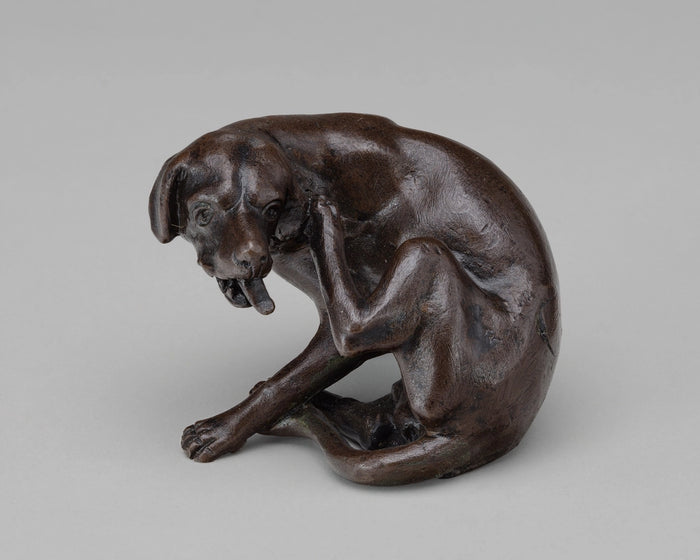 Bronze sculpture of a dog scratching an itch