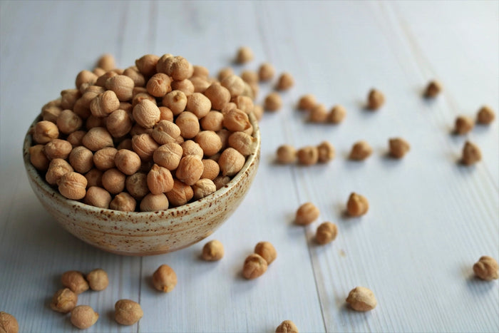 Bowl of dried chickpeas on a white table