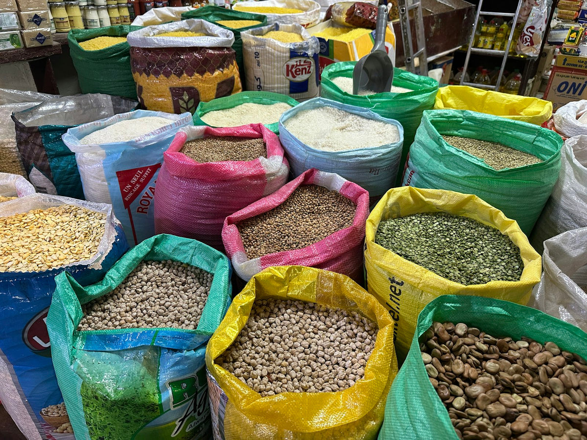 Open sacks of grains, lentils and pulses at a market stall